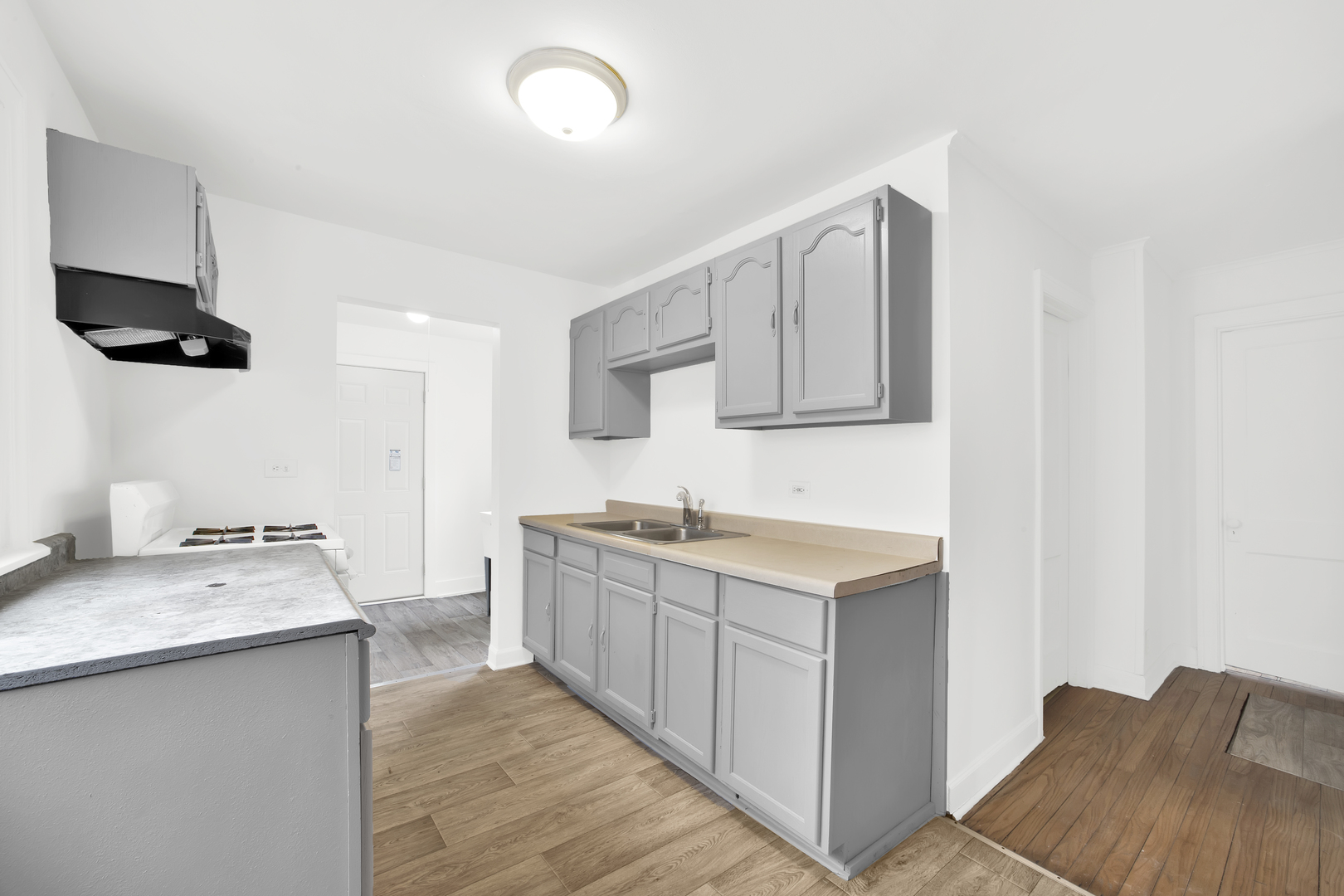 15014 Ridgeway Avenue Midlothian, IL 60445 - Photo 5 of 18 a kitchen with a sink stove and cabinets