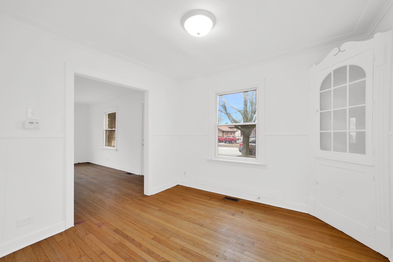 15014 Ridgeway Avenue Midlothian, IL 60445 - Photo 9 of 18 an empty room with wooden floor and windows
