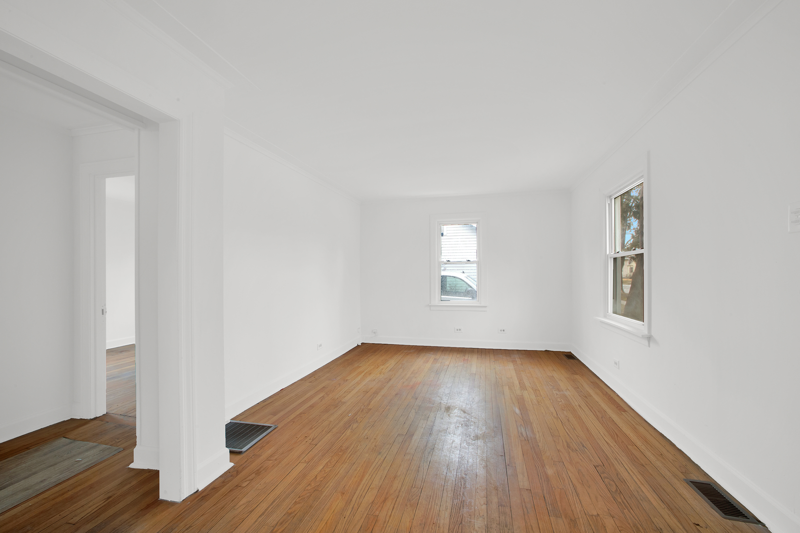 15014 Ridgeway Avenue Midlothian, IL 60445 - Photo 10 of 18 an empty room with wooden floor and windows