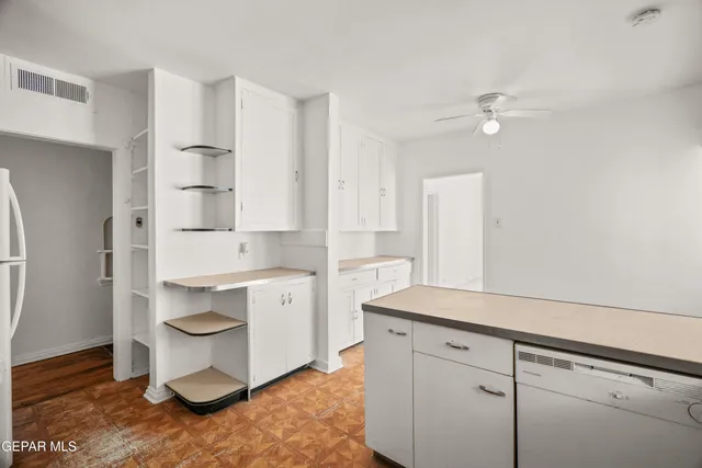 a kitchen with a sink cabinets and window