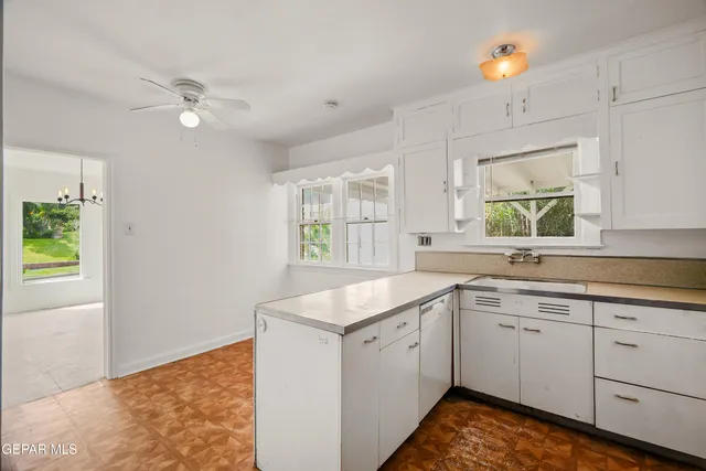 a kitchen with stainless steel appliances a refrigerator and cabinets