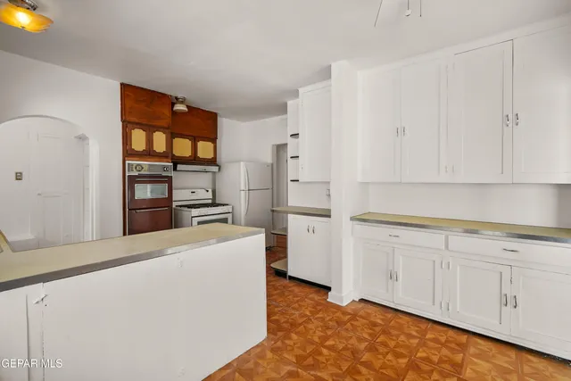 a kitchen with a stove a sink and a refrigerator