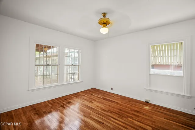 a view of a room with wooden floor and window