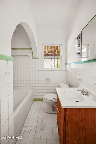 a view of a patio with table and chairs under an umbrella