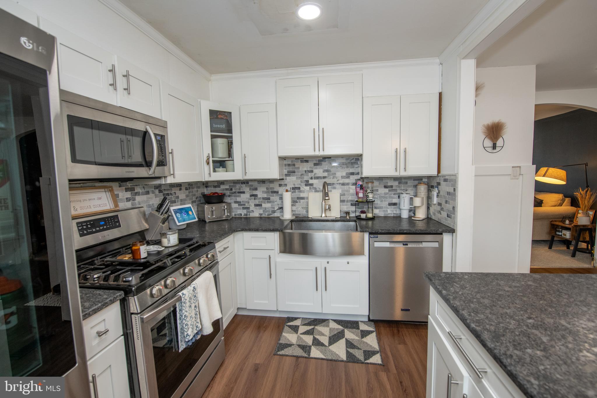 3141 Belgreen Road Philadelphia, PA 19154 - Photo 18 of 51 a kitchen with stainless steel appliances granite countertop a stove a sink and a microwave