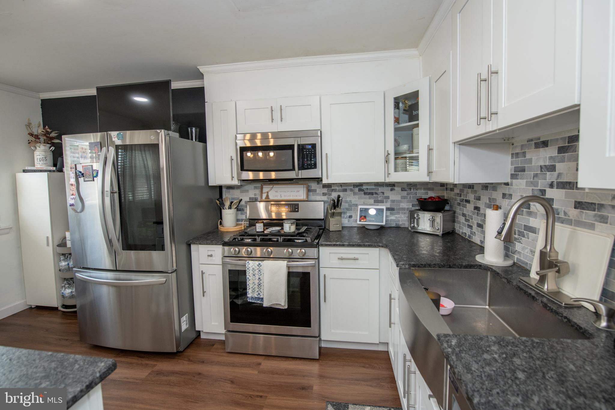 3141 Belgreen Road Philadelphia, PA 19154 - Photo 20 of 51 a kitchen with stainless steel appliances granite countertop a refrigerator a stove a sink and a microwave