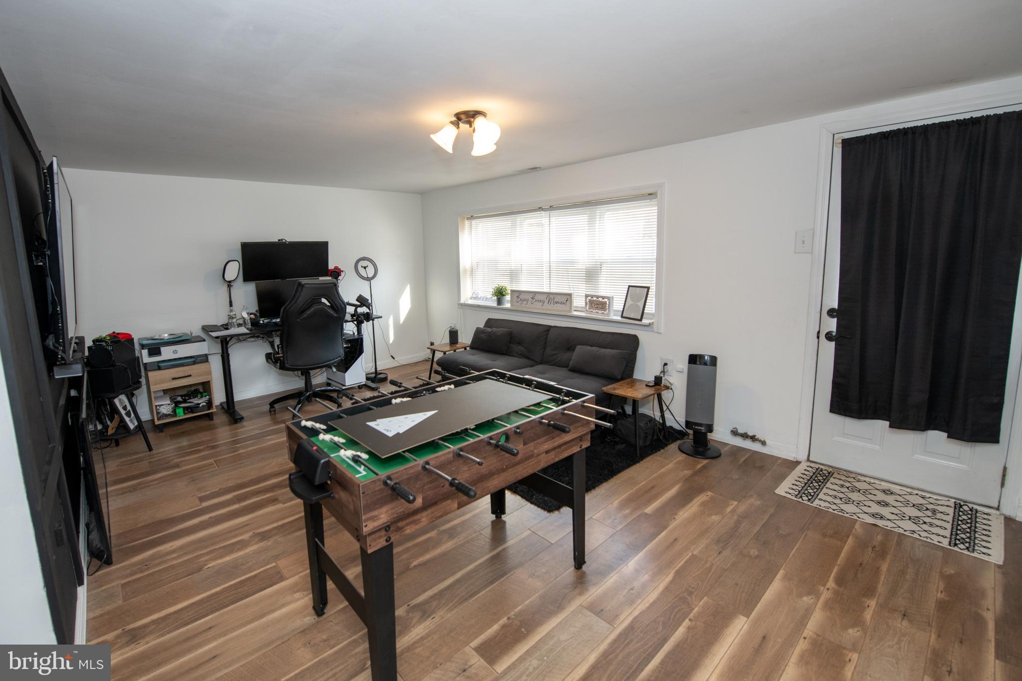 3141 Belgreen Road Philadelphia, PA 19154 - Photo 45 of 51 a living room with furniture a flat screen tv and a piano