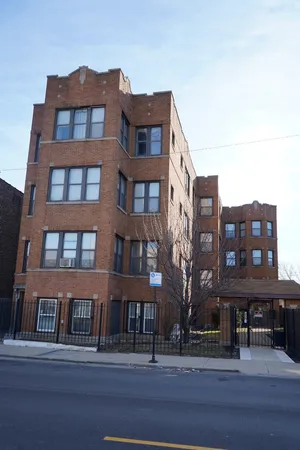 a front view of a residential apartment building with a yard
