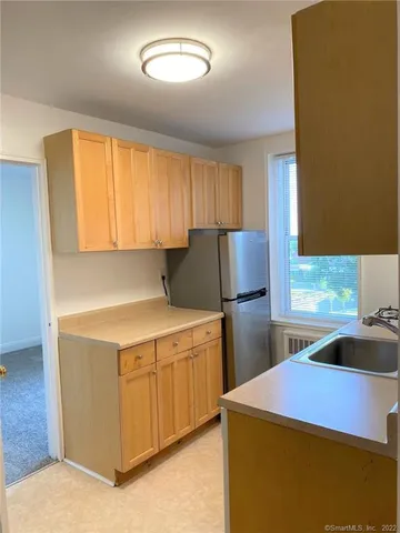 a kitchen with a sink a stove and a refrigerator