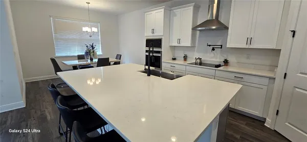 a kitchen with a table chairs and a stove