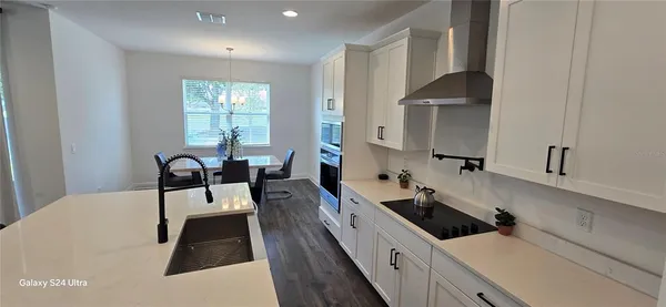 a kitchen with a sink a counter space and cabinets