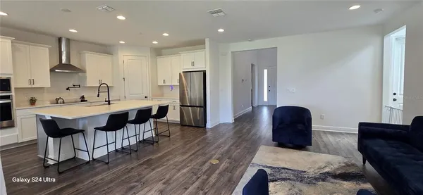 a large kitchen with a table and chairs