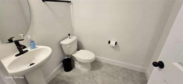 a white toilet sitting next to a bathroom sink