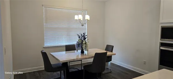 a view of a dining room with furniture and window