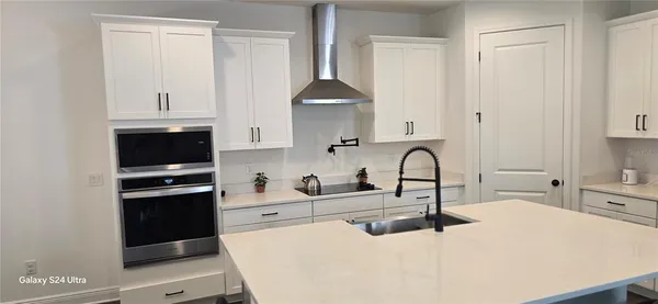 a kitchen with stainless steel appliances a stove and a refrigerator