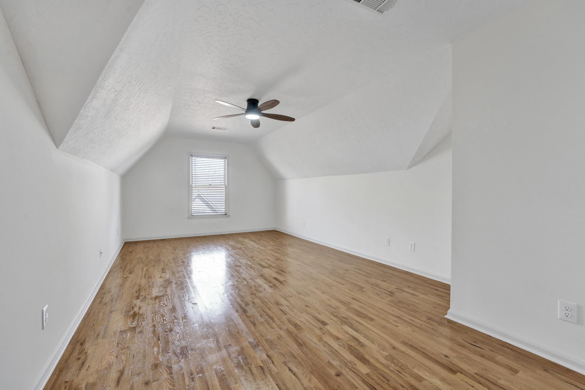 5379 Bentley Place Memphis, TN 38120 - Photo 11 of 25 an empty room with wooden floor and windows