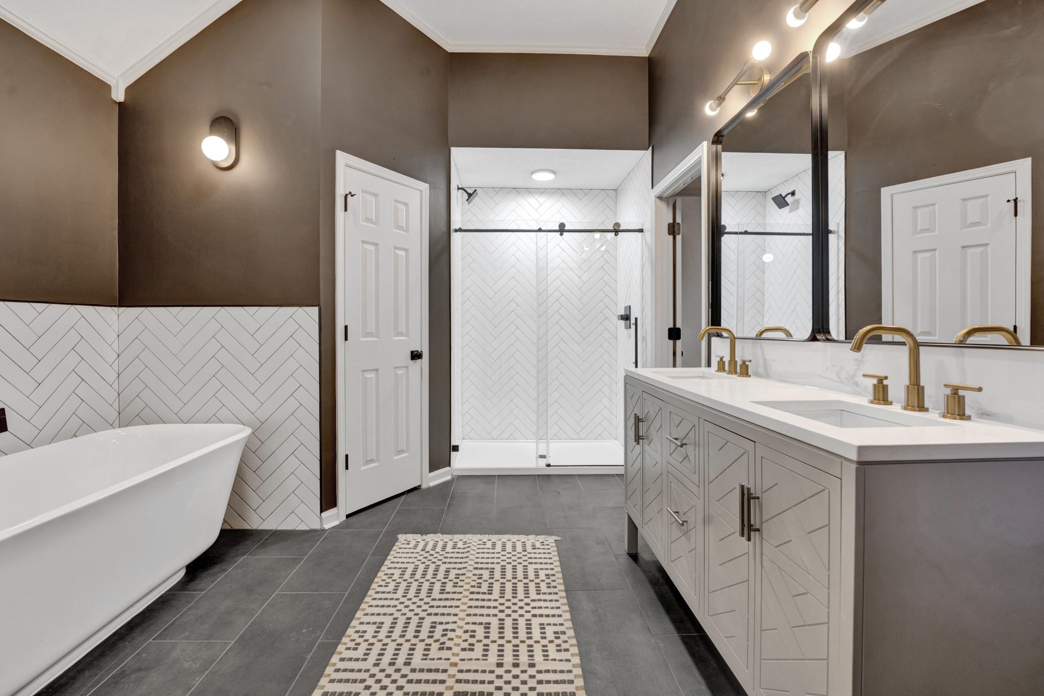 5379 Bentley Place Memphis, TN 38120 - Photo 13 of 25 a spacious bathroom with a double vanity sink a mirror and a bathtub