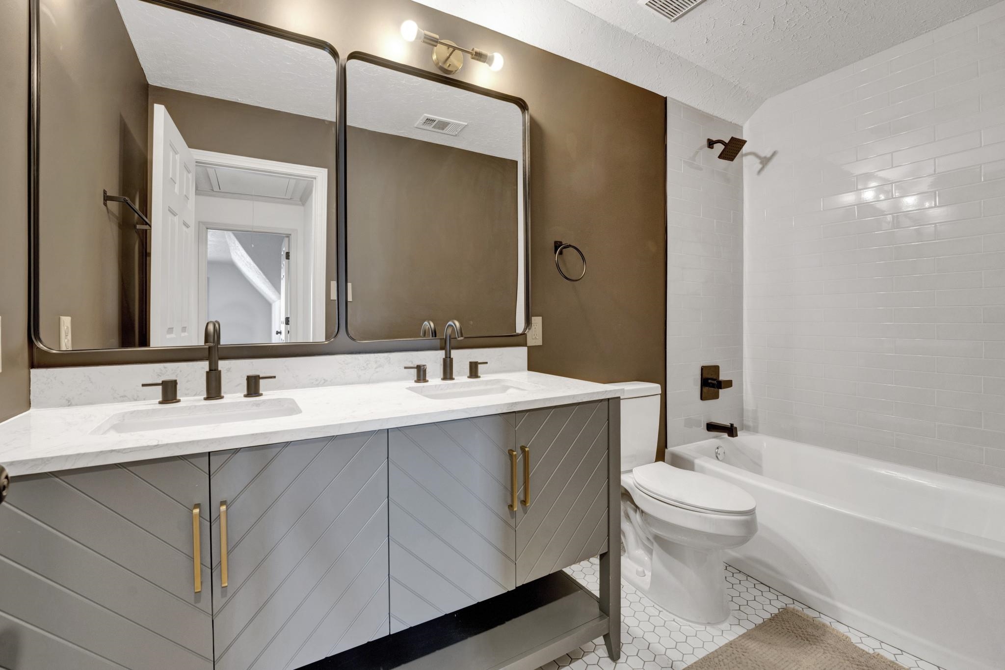 5379 Bentley Place Memphis, TN 38120 - Photo 18 of 25 a bathroom with a double vanity sink mirror and toilet