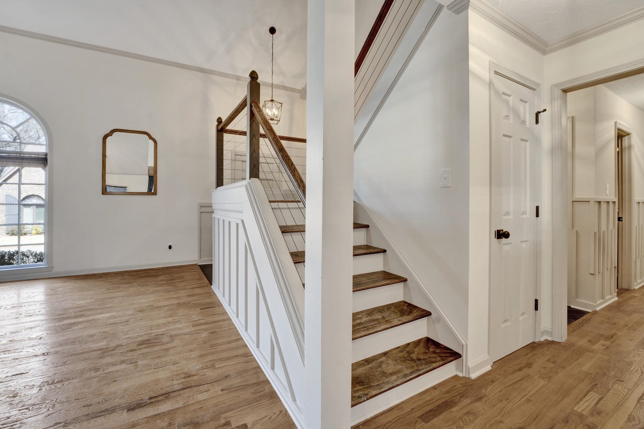 5379 Bentley Place Memphis, TN 38120 - Photo 19 of 25 a view of a hallway with wooden floor and staircase