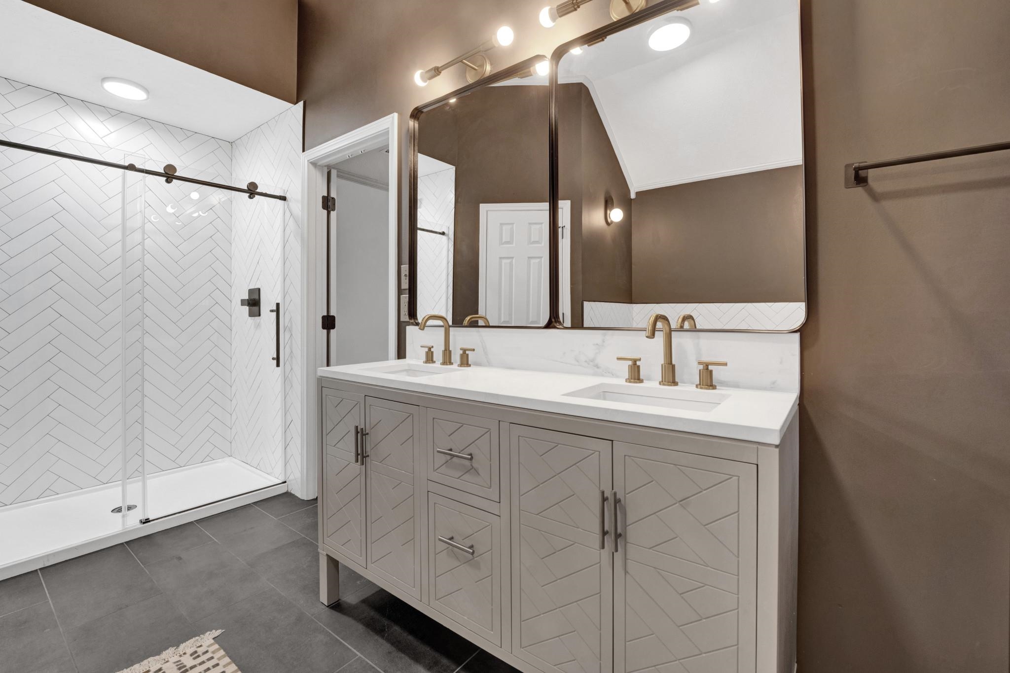 5379 Bentley Place Memphis, TN 38120 - Photo 6 of 25 a bathroom with a double vanity sink mirror and shower