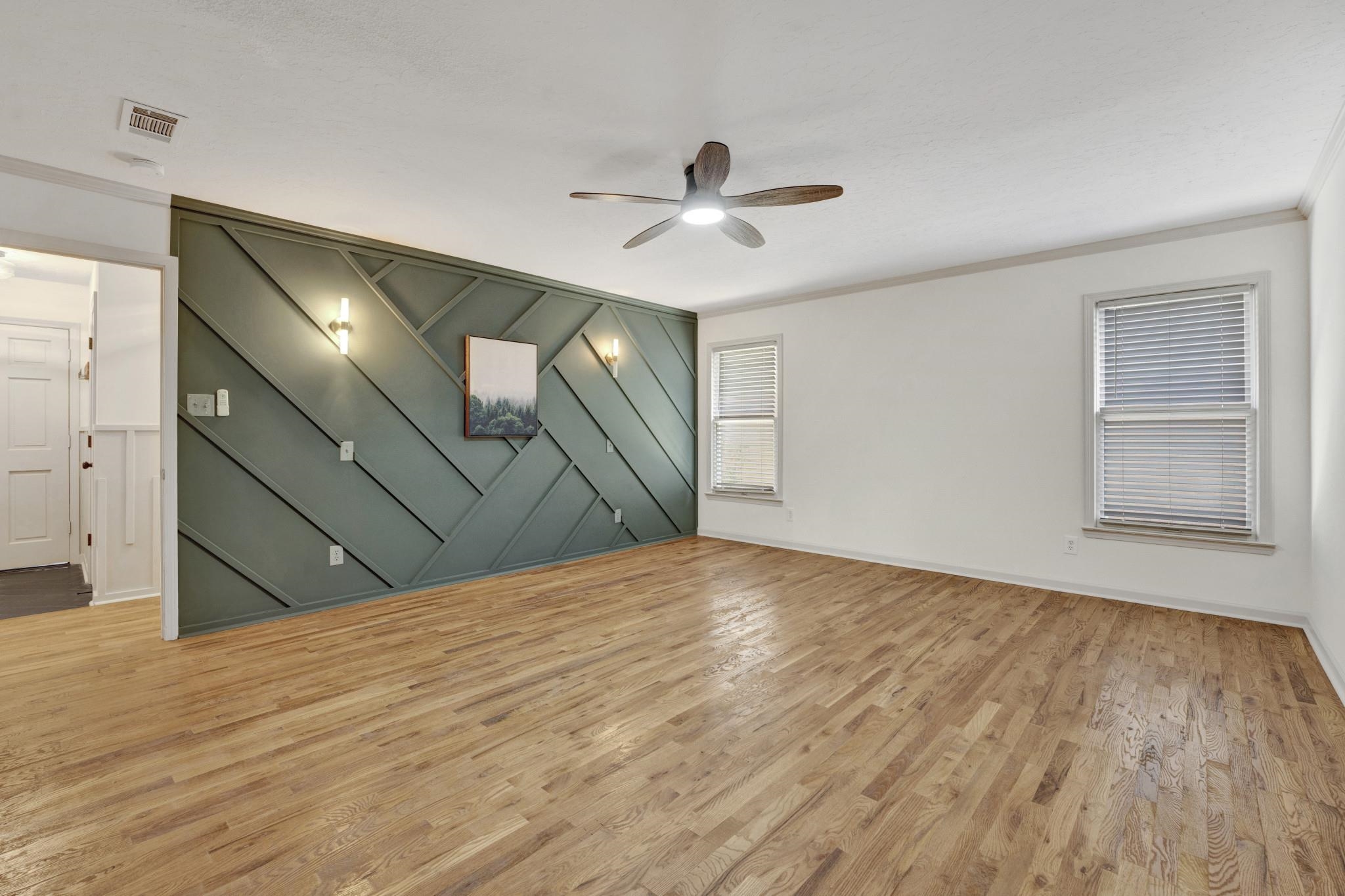 5379 Bentley Place Memphis, TN 38120 - Photo 9 of 25 a view of empty room with wooden floor and fan