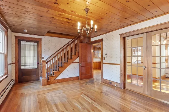 a view of entryway and hall with wooden floor