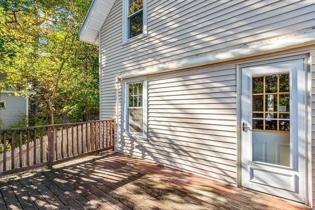 a view of a backyard with plants and wooden fence
