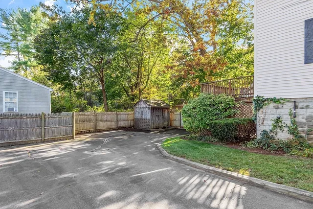 a view of a white house with a yard and plants