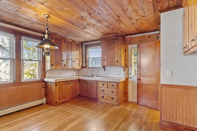 a kitchen with stainless steel appliances granite countertop a sink stove and wooden floors
