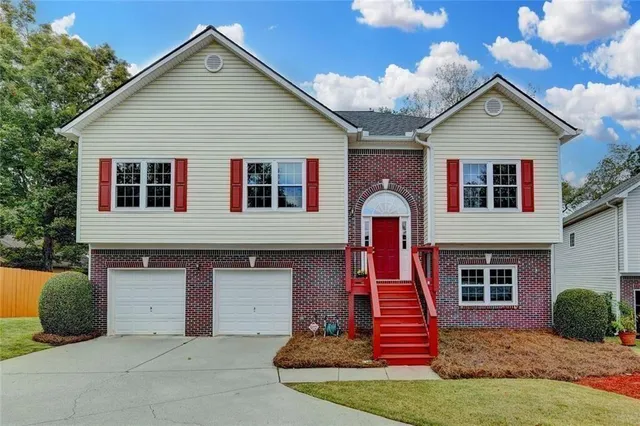 a front view of a house with a yard and garage