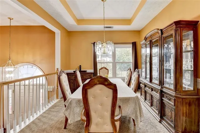 a kitchen with stainless steel appliances a table chairs and a stove