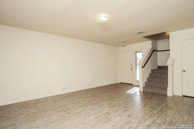 a view of an empty room with stairs
