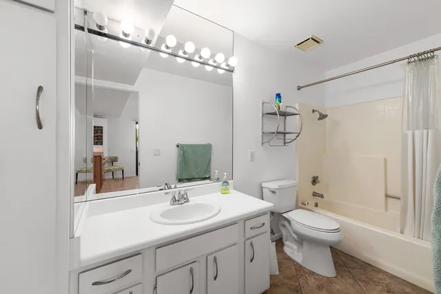 a bathroom with a toilet a sink and a mirror