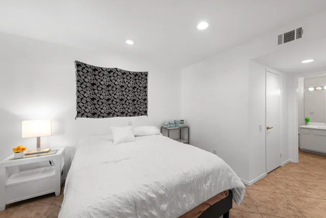 a bedroom with a white bed and a cabinets