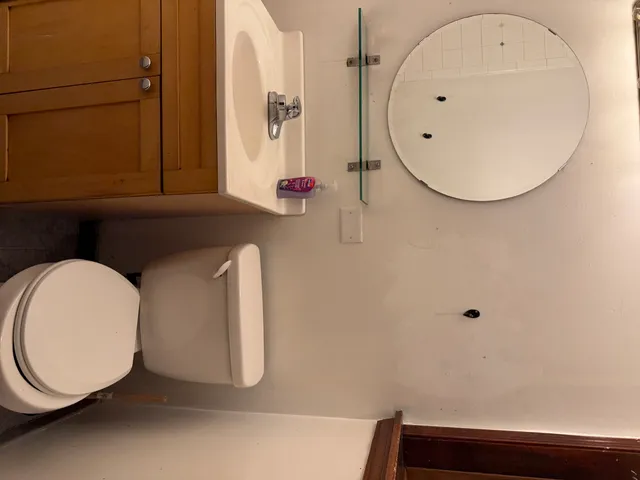 a bathroom with a sink mirror and vanity