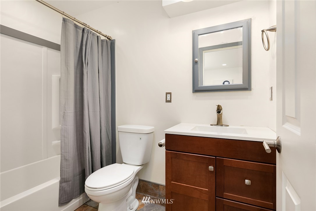 23818 1st Avenue West Bothell, WA 98021 - Photo 15 of 20 a bathroom with a toilet a sink and a mirror