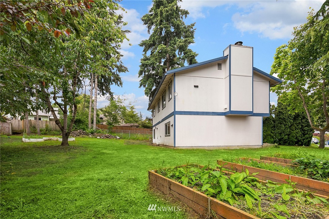 23818 1st Avenue West Bothell, WA 98021 - Photo 18 of 20 a view of a house with a yard and a large tree