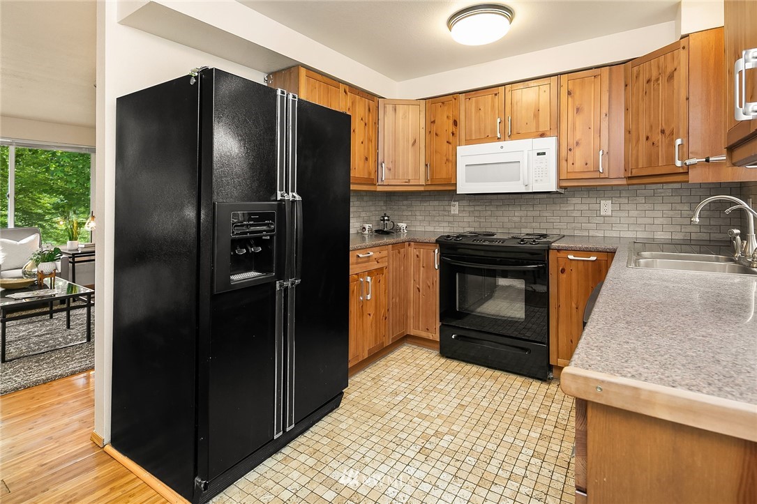 23818 1st Avenue West Bothell, WA 98021 - Photo 6 of 20 a kitchen with granite countertop a refrigerator stove and sink