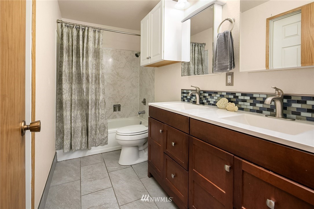 23818 1st Avenue West Bothell, WA 98021 - Photo 9 of 20 a bathroom with a sink a toilet and shower