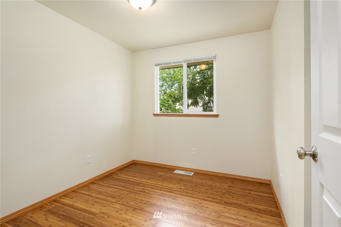 23818 1st Avenue West Bothell, WA 98021 - Photo 10 of 20 an empty room with wooden floor and windows
