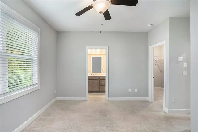 a view of a livingroom with a ceiling fan and window