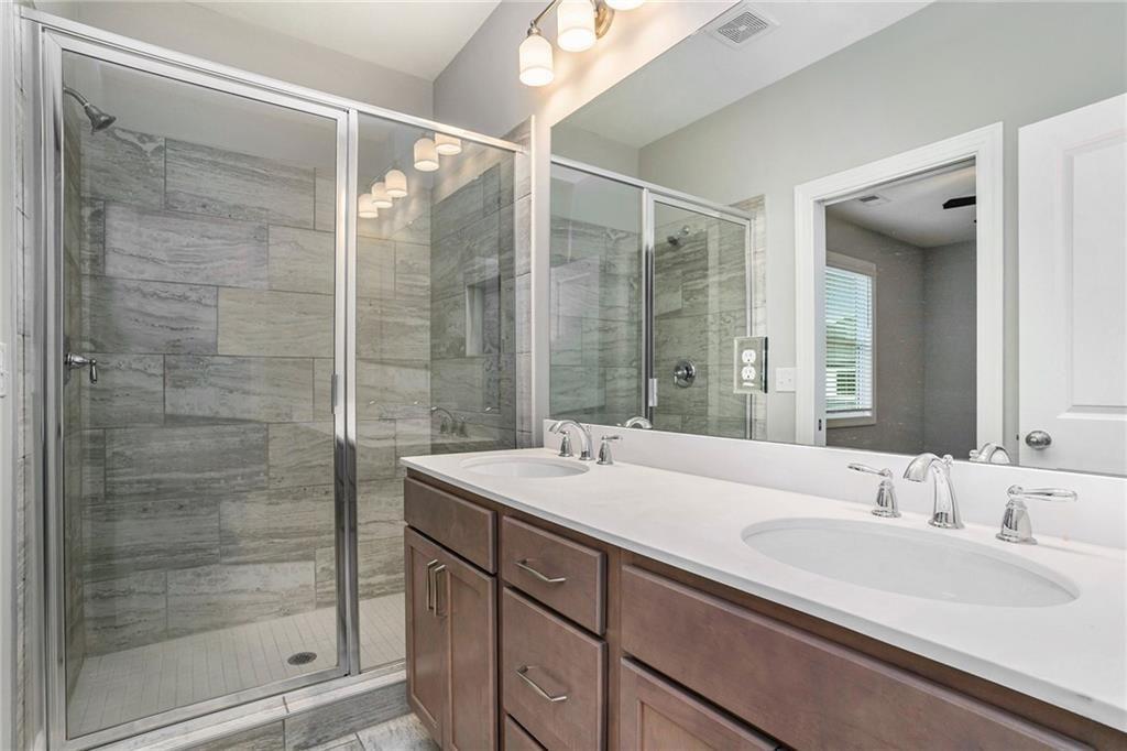 1341 Parc Bench Road Atlanta, GA 30316 - Photo 15 of 28 a bathroom with a double vanity sink mirror and shower