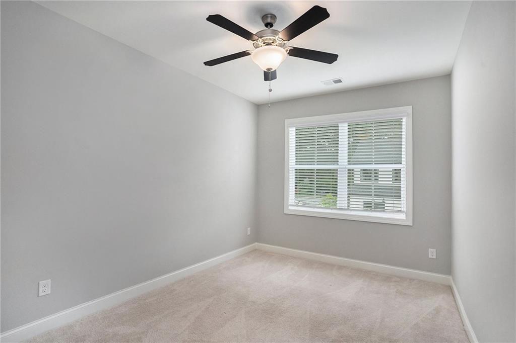 1341 Parc Bench Road Atlanta, GA 30316 - Photo 17 of 28 an empty room with a window and a ceiling fan