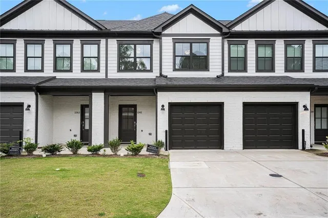 front view of a brick house with a yard