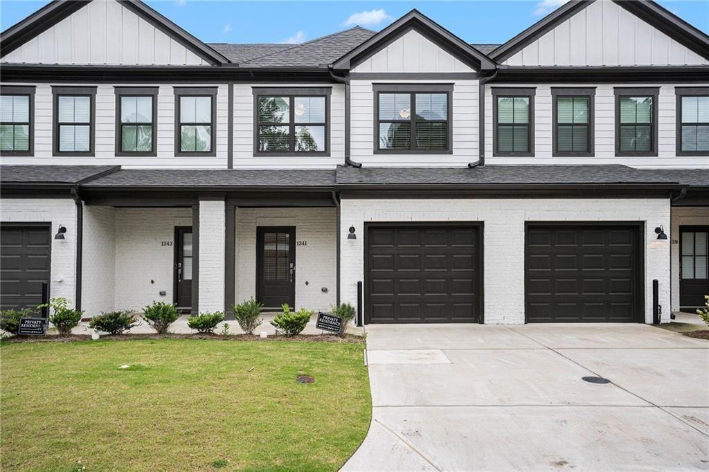 1341 Parc Bench Road Atlanta, GA 30316 - Photo 4 of 28 front view of a brick house with a yard