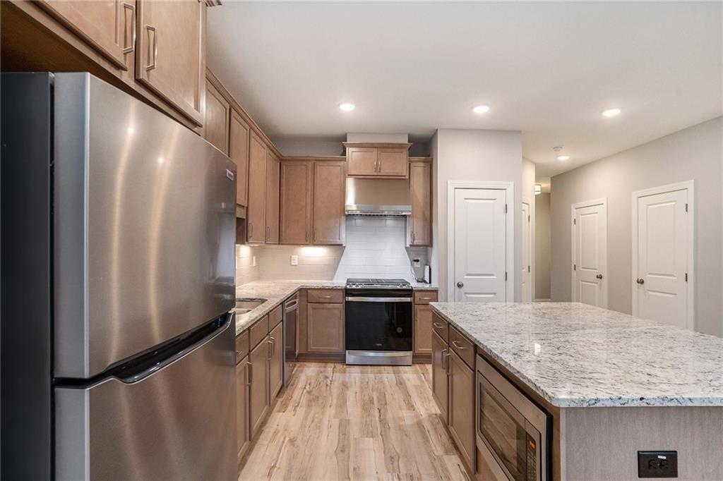 1341 Parc Bench Road Atlanta, GA 30316 - Photo 9 of 28 a kitchen with stainless steel appliances granite countertop a refrigerator a sink and a stove