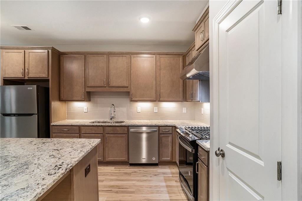 1341 Parc Bench Road Atlanta, GA 30316 - Photo 10 of 28 a kitchen with stainless steel appliances granite countertop a sink stove and refrigerator