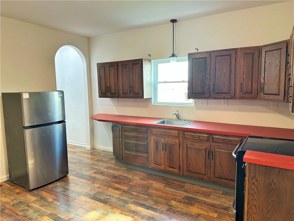 308 West Cherry Street New Castle, PA 16102 - Photo 11 of 25 a kitchen with stainless steel appliances granite countertop a refrigerator a sink a stove a washer and dryer with wooden floor