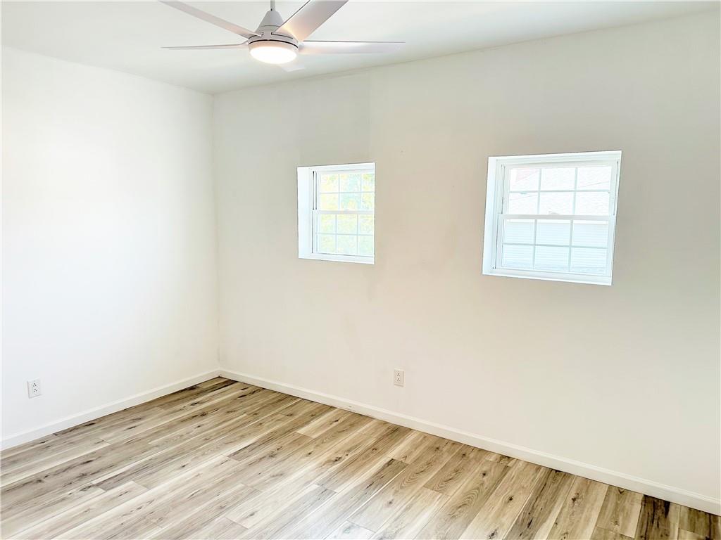 308 West Cherry Street New Castle, PA 16102 - Photo 16 of 25 an empty room with a window and wooden floor