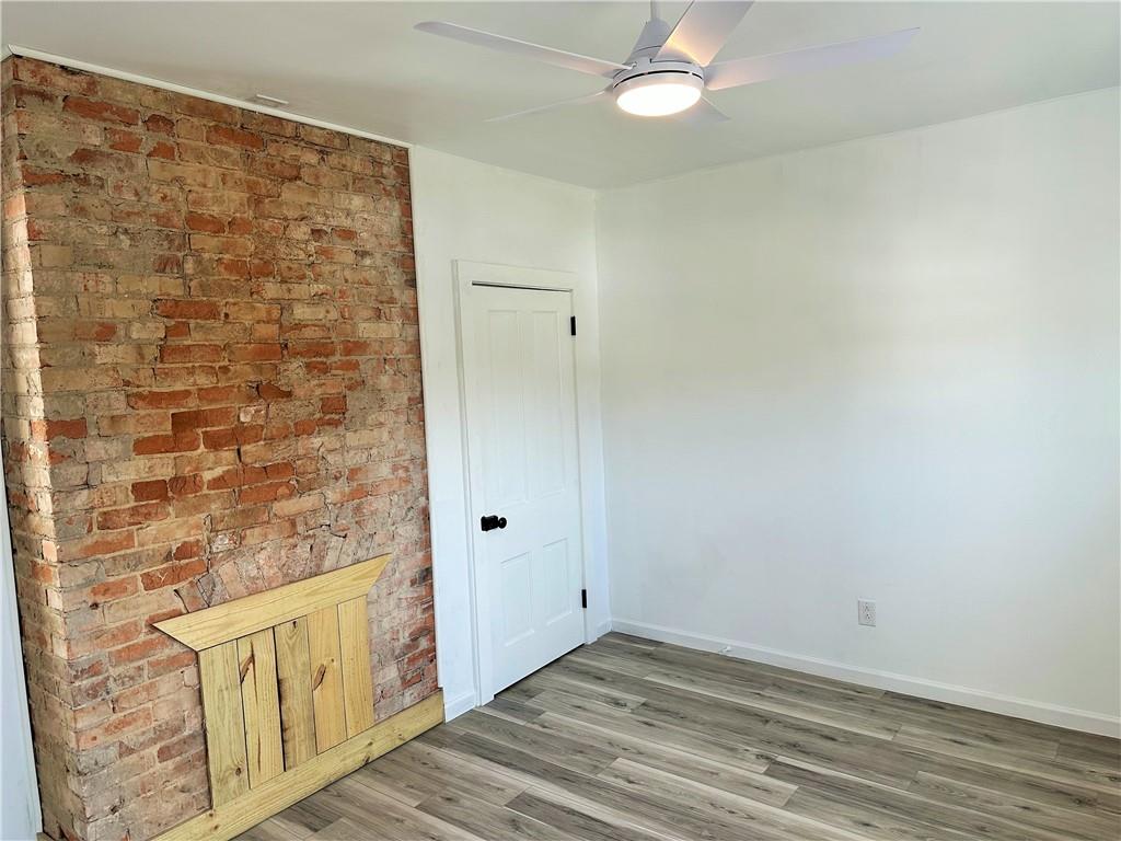 308 West Cherry Street New Castle, PA 16102 - Photo 17 of 25 a view of an empty room with wooden floor and a window